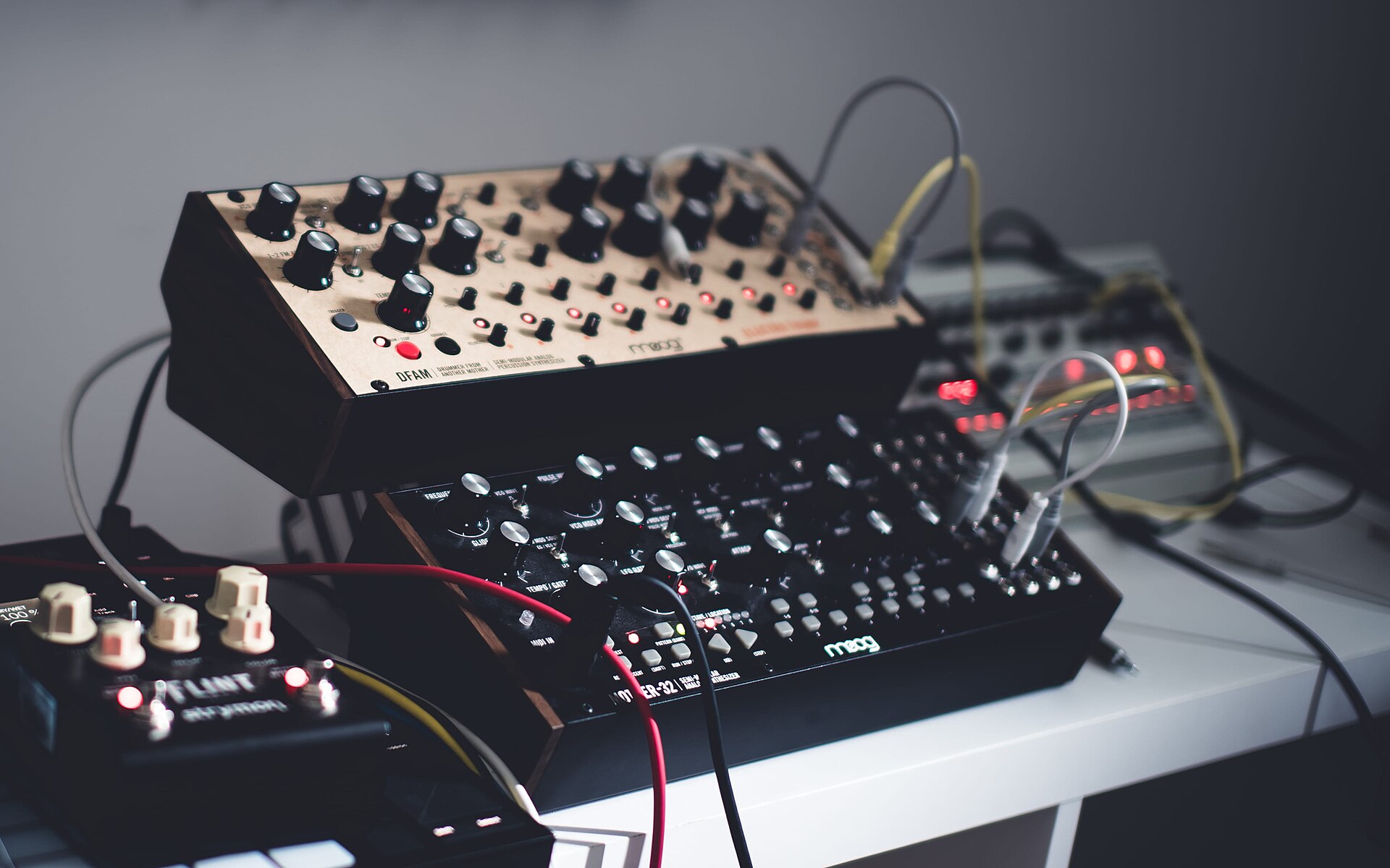 A Moog DFAM and Mother-32 semi-modular synthesizer on a desk. Photograph via Wikimedia Commons, CC0.